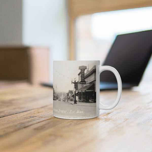 Nice view of Sheridan Street in downtown Ely, Minnesota from 1938, White Ceramic Mug